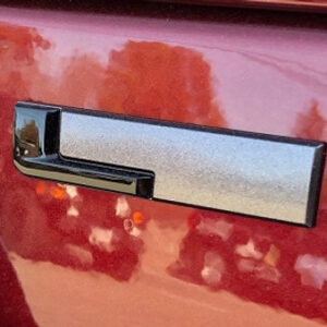 Gloss Black "L" Liftgate Badge from the 2021-2025 Grand Cherokee L